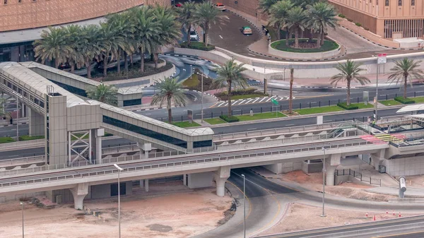 Aerial top view of traffic near mall with footbridge from tram stop timelapse in Dubai Marina in Dubai, UAE. — Stock Photo, Image