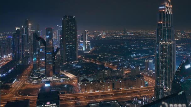 Dubai International Financial Centre district with modern skyscrapers at night — 비디오