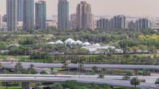 Dubai Golf Course con un paisaje urbano de Gereens y los distritos de tecom en el timelapse aéreo de fondo — Vídeos de Stock