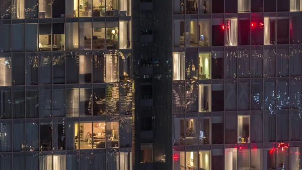 Nachtzicht van exterieur appartement toren timelapse. Hoge wolkenkrabber met knipperende lichten in ramen — Stockfoto