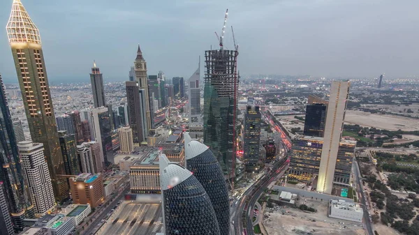 Skyline of the buildings of Sheikh Zayed Road and DIFC aerial day to night timelapse in Dubai, UAE. — Stock Photo, Image