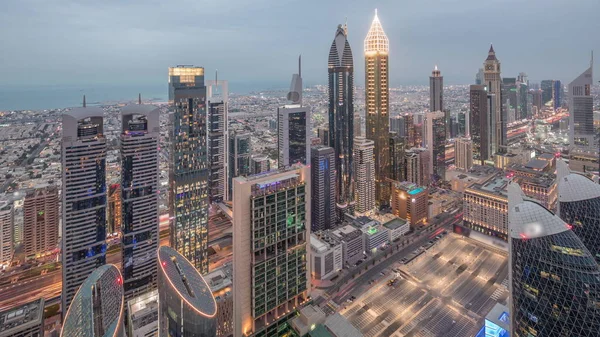 Skyline of the building of Sheikh Zayed Road and DIFC airline day to night timelape in Dubai, UAE . — стоковое фото