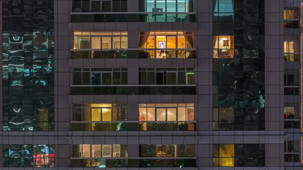 Night view of exterior apartment building timelapse. High rise skyscraper with blinking lights in windows — Stock Photo, Image