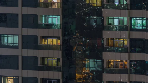 Night view of exterior apartment building timelapse. High rise skyscraper with blinking lights in windows — Stock Photo, Image