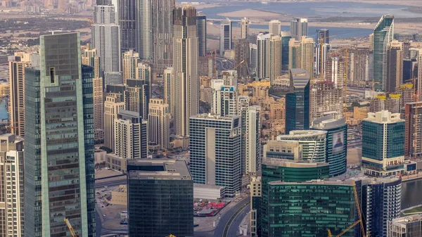 Panoramic aerial view of business bay towers in Dubai at evening timelapse. — Stock Photo, Image