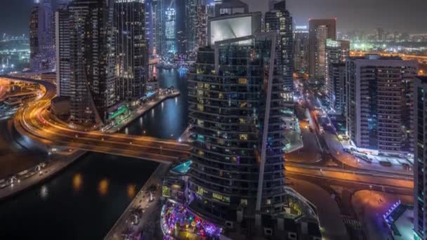 Aerial view of Dubai Marina residential and office skyscrapers with waterfront night timelapse — ストック動画