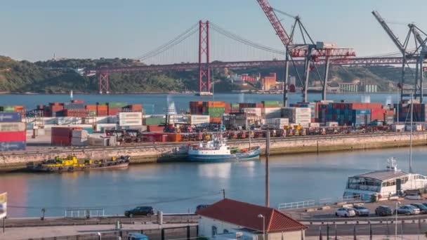 Skyline over Lisbon commercial port timelapse, 25th April Bridge, containers on pier with freight cranes — 图库视频影像