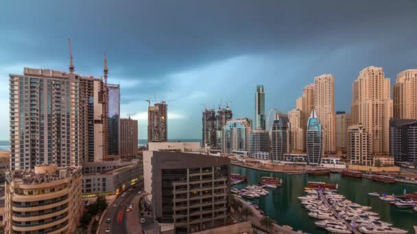 Luxury yachts parked on the pier in Dubai Marina bay with city aerial view timelapse — Stock Video