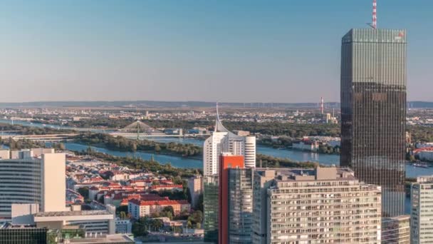 Aerial panoramic view of Vienna city with skyscrapers, historic buildings and a riverside promenade timelapse in Austria. — Stock Video