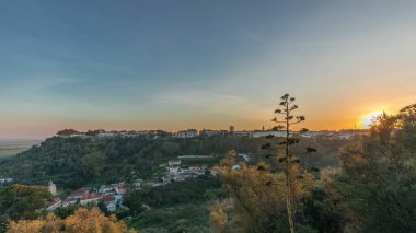 Panorama showing sunset over the Castle of Almourol on hill in Santarem aerial timelapse. A medieval castle atop the islet of Almourol in the middle of the Tagus River and houses. Portugal clipart