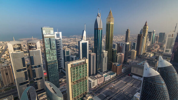 Skyline view of the buildings of Sheikh Zayed Road and DIFC aerial timelapse during sunrise in Dubai, UAE. Modern towers and skyscrapers in financial center and downtown
