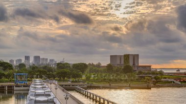 Marina Barrage 'da güzel bir gün doğumu zamanı. Turuncu gökyüzü ve güneş ışınlı bulutlar. Singapur 'un 15. su deposu ve şehrin göbeğindeki ilk su deposudur..