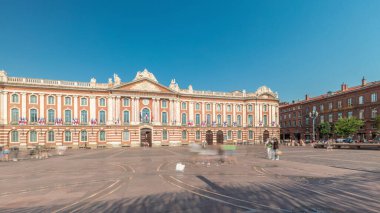 Capitole de Toulouse zaman çizelgesini gösteren panorama, Fransa 'nın Toulouse şehrinin tarihi belediye binası ve belediye kalbini, Capitole Meydanı' nda, çarpıcı mavi bulutlu gökyüzünün altında sergiliyor.