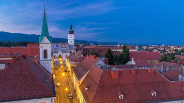 Church of St. Mark day to night transition timelapse and parliament building Zagreb, Croatia. Top view from Kula Lotrscak tower viewpoint after sunset
