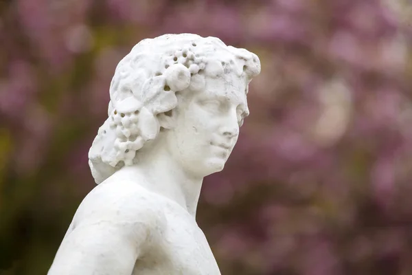 ancient greek statue in park at sunny day