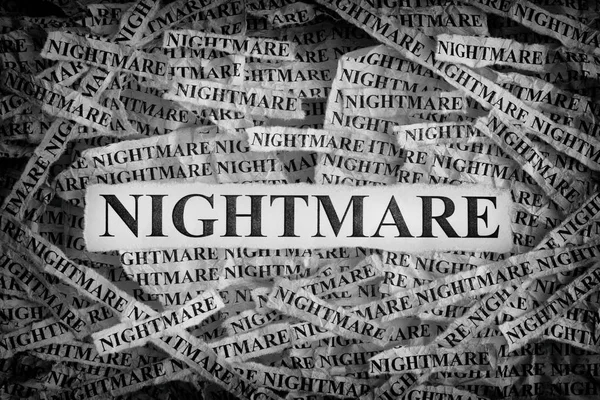 Nightmare. Torn pieces of paper with the words Nightmare. Concept Image. Black and White. Closeup.