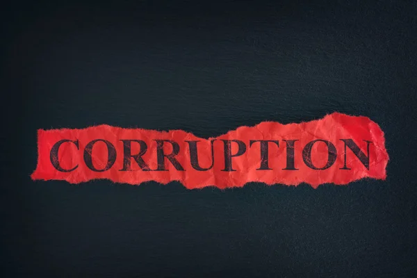 Torn piece of paper with the word Corruption — Stock Photo, Image