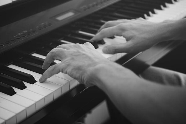 Pianist playing on a digital piano. Black and White.
