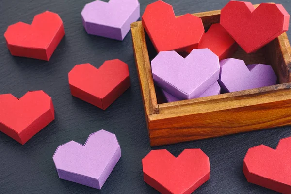 Origami hearts inside wooden box — Stock Photo, Image