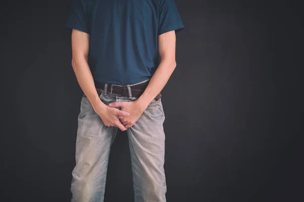 Homem Jeans Cobre Virilha Com Mãos Contra Parede Preta Fechar — Fotografia de Stock