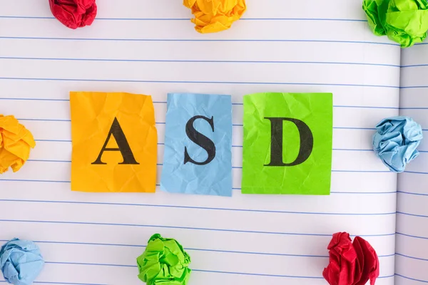 ASD (Autism spectrum disorder) on notebook sheet with some color — Stock Photo, Image