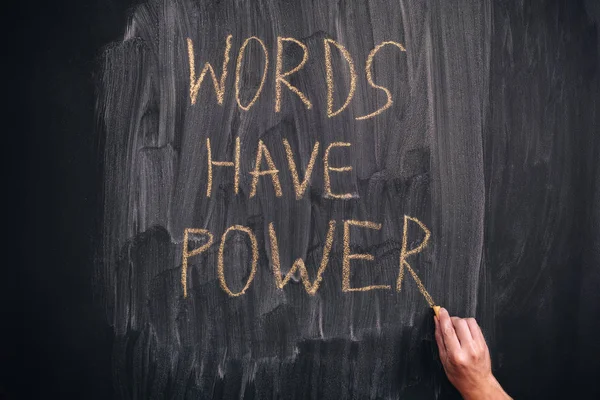 Person writing phrase Words Have Power on a blackboard — Stock Photo, Image