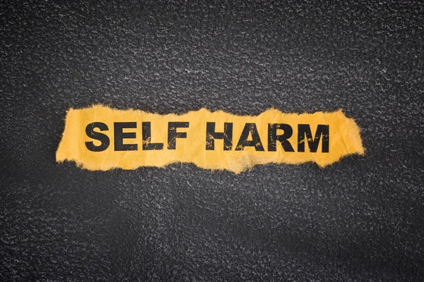 Crumpled piece of paper with words Self Harm — Stock Photo, Image
