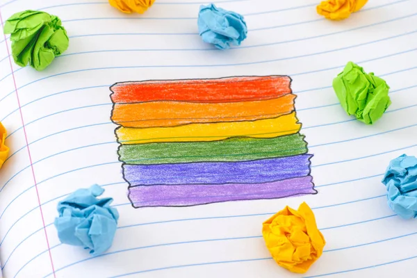 Gay pride rainbow flag on notebook sheet — Stock Photo, Image