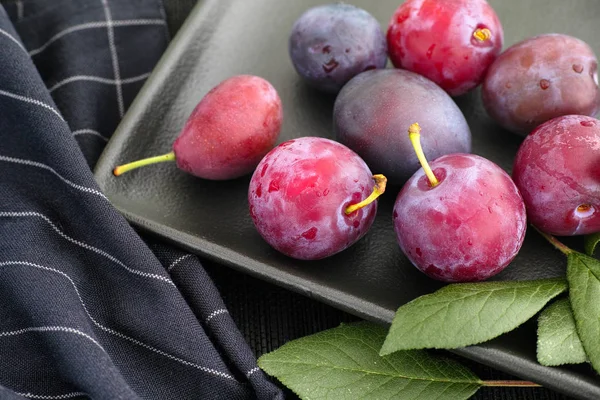 Fresh harvested organic plums in a plate — Stock Photo, Image