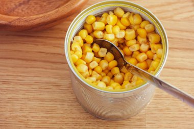 Canned corn on a wooden table