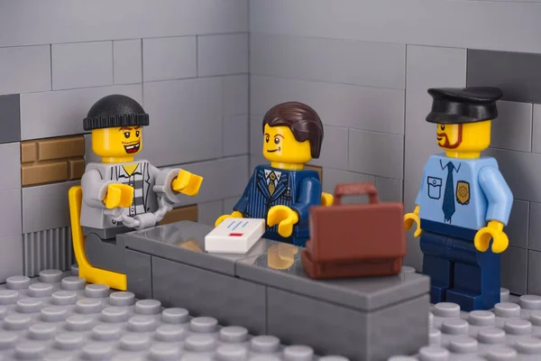 Three lego minifigures in a jail scene — Stock Photo, Image