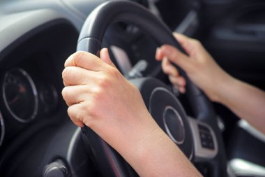Woman driving a car. Close up.