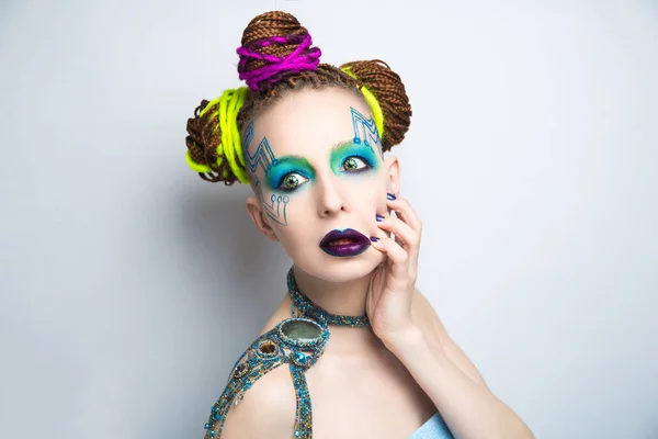 Girl woman creative make-up, lines motherboard painted on her face. Long fingers with manicure. Purple violet lips, eyes lenses, colored blue green shadows. Hair dreadlocks braided, neon yellow string