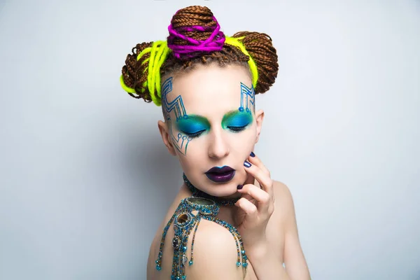 Girl woman creative make-up, lines motherboard painted on her face. Long fingers with manicure. Purple violet lips, eyes lenses, colored blue green shadows. Hair dreadlocks braided, neon yellow string