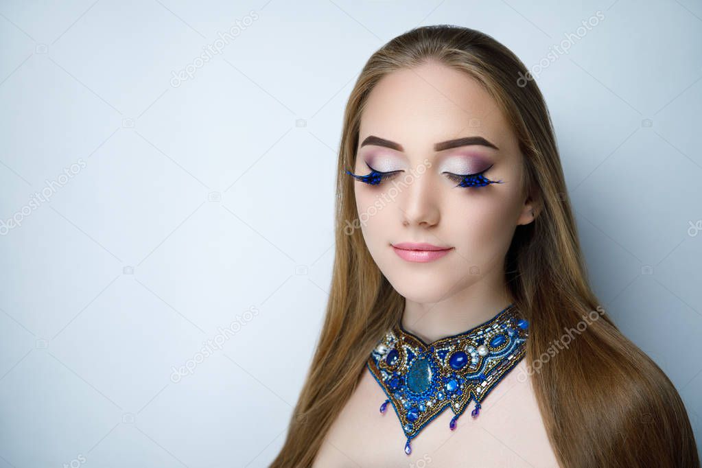 Beautiful woman lady girl with long golden hair, high quality coloring, hairdresser ads, beauty saloon. Banner for advertising shampoo or hair care products. Massive necklace, blue beads gems stones