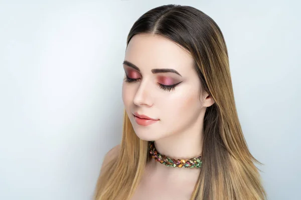 New stylish make-up, conceptual art idea. Marsala shadows, vivid colors graphic shapes lines, cosmetics paints, necklace jewellery. close-up photo. skin painting artistic. perfect straight golden hair