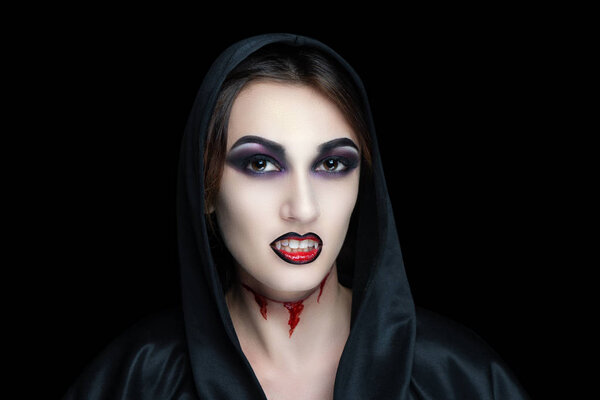 Scary vampire make-up for Halloween. Cut skin on throat, blood flowing from wounds. Black shadows smoky eyes. Horrors of terrible nightmares. Large hood cape woman vamp. Horizontal banner concept idea
