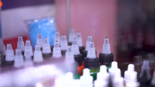 Many professional bottles with colored ink for tattoos. — Stock Video