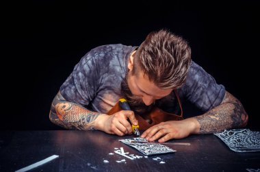 Deri zanaatkar deriden bir iş parçası işler 