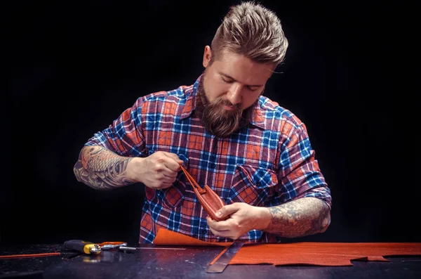 Professional Leather Worker at work in workshop