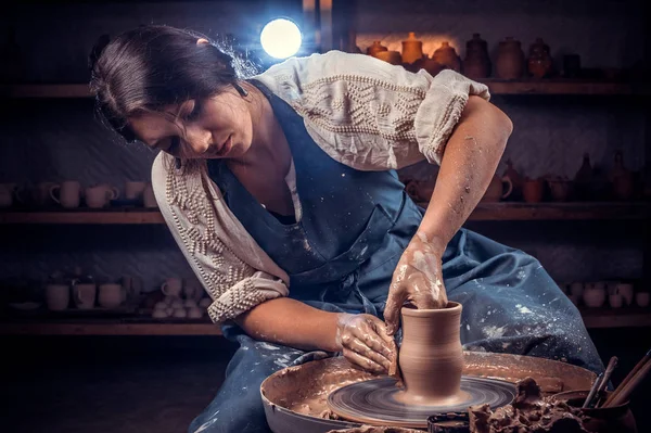 Charming female master molding a vase of clay on a potters wheel. Handicraft production. — Stock Photo, Image