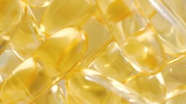 Yağ kapsülleri kontrast ışık parlak sarı. Arka planlar ve dokular.