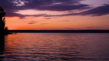 Beautiful pink colors reflect off Lake. Idyllic picture.