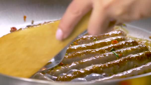 Τα κορόιδα τηγανίζονται σε ένα τηγάνι και πασπαλίζονται με μπαχαρικά.. — Αρχείο Βίντεο