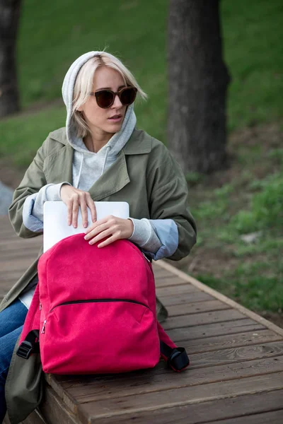 Young woman with backpack in city