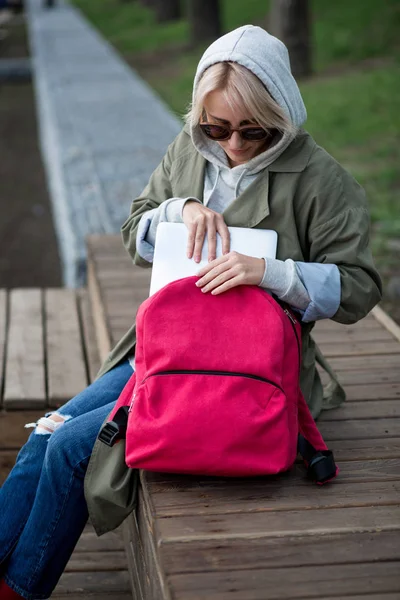 Young woman with backpack in city