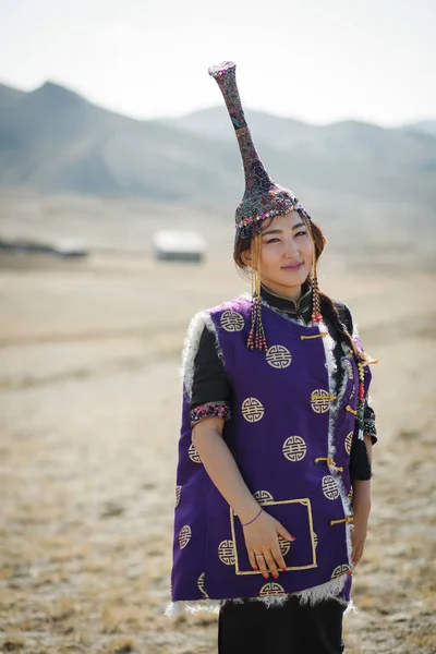 Portrait tuvan girl in national dress in the steppe with national yurt