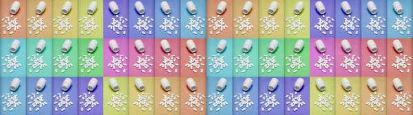 Medication bottle and white pills spilled on pastel coloured backgrounds. Medication and prescription pills flat lay background. Creative Opioid epidemic concept.