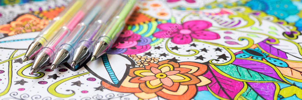 Adult coloring book, new stress relieving trend. Art therapy, mental health, creativity and mindfulness concept. Web banner, panoramic close up shot.