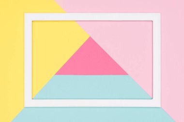 Soyut geometrik pastel mavi, pembe ve sarı kağıt düz yatıyordu arka plan. Boş resim çerçevesini sahte kadar minimalizm, geometri ve simetri şablonuyla.